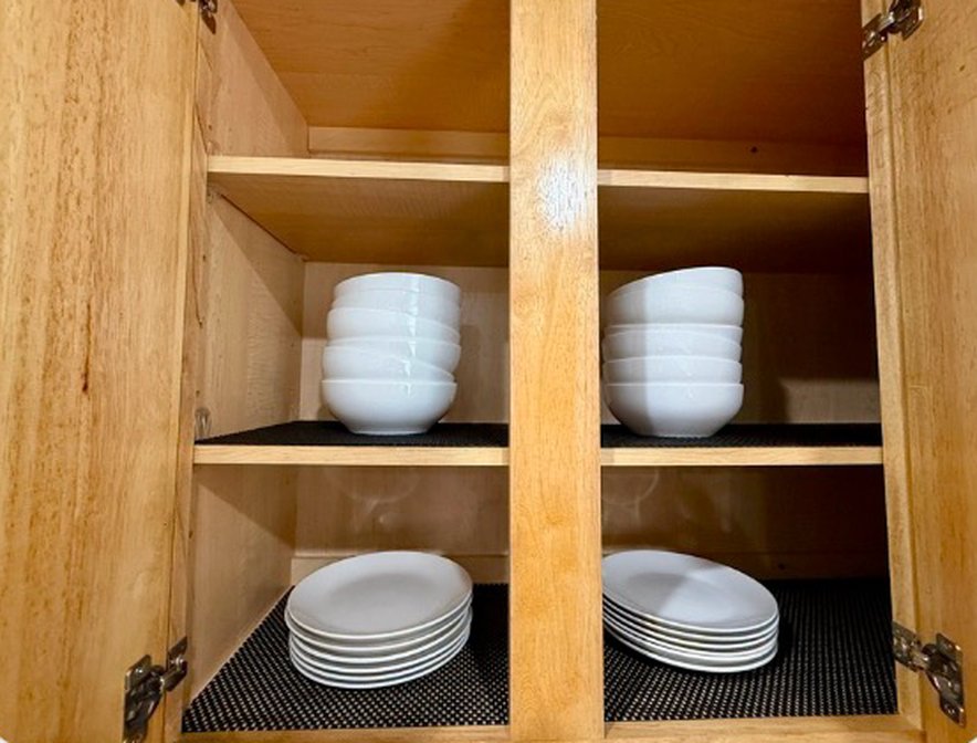 Cabinet with white bowls and plates
