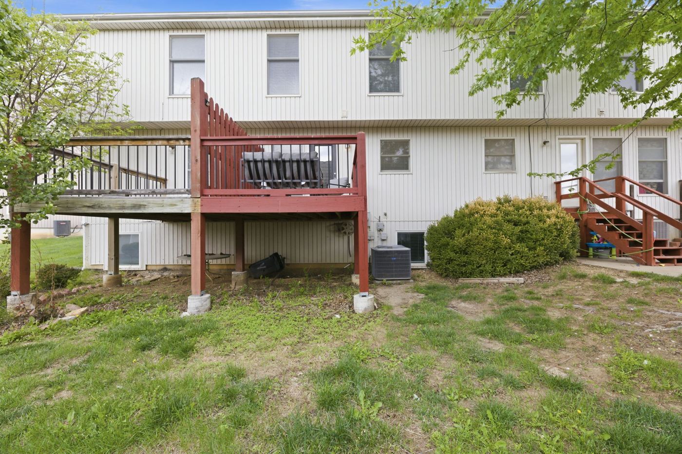 Back of the home with the deck and yard